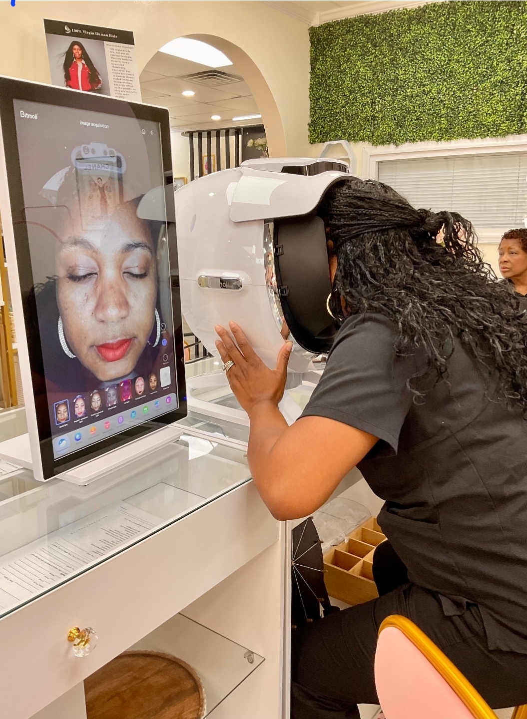 Client receiving Bitmoli skin analysis scan at Sinkor Beauty Salon Delaware