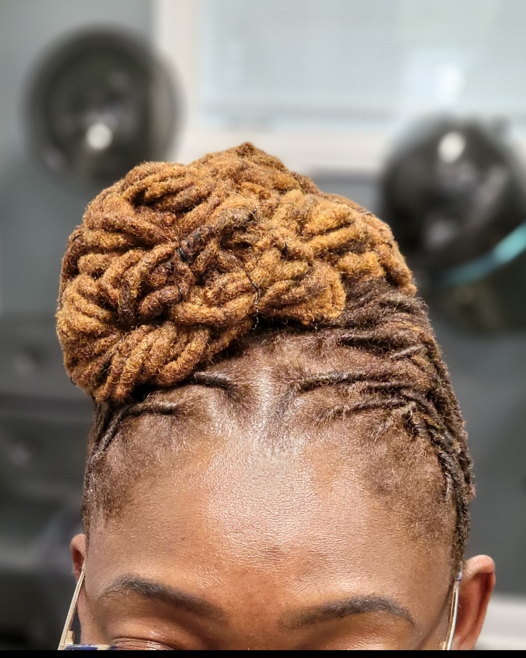 Golden loc bun front view — loc updo styling at Sinkor Beauty Salon Delaware