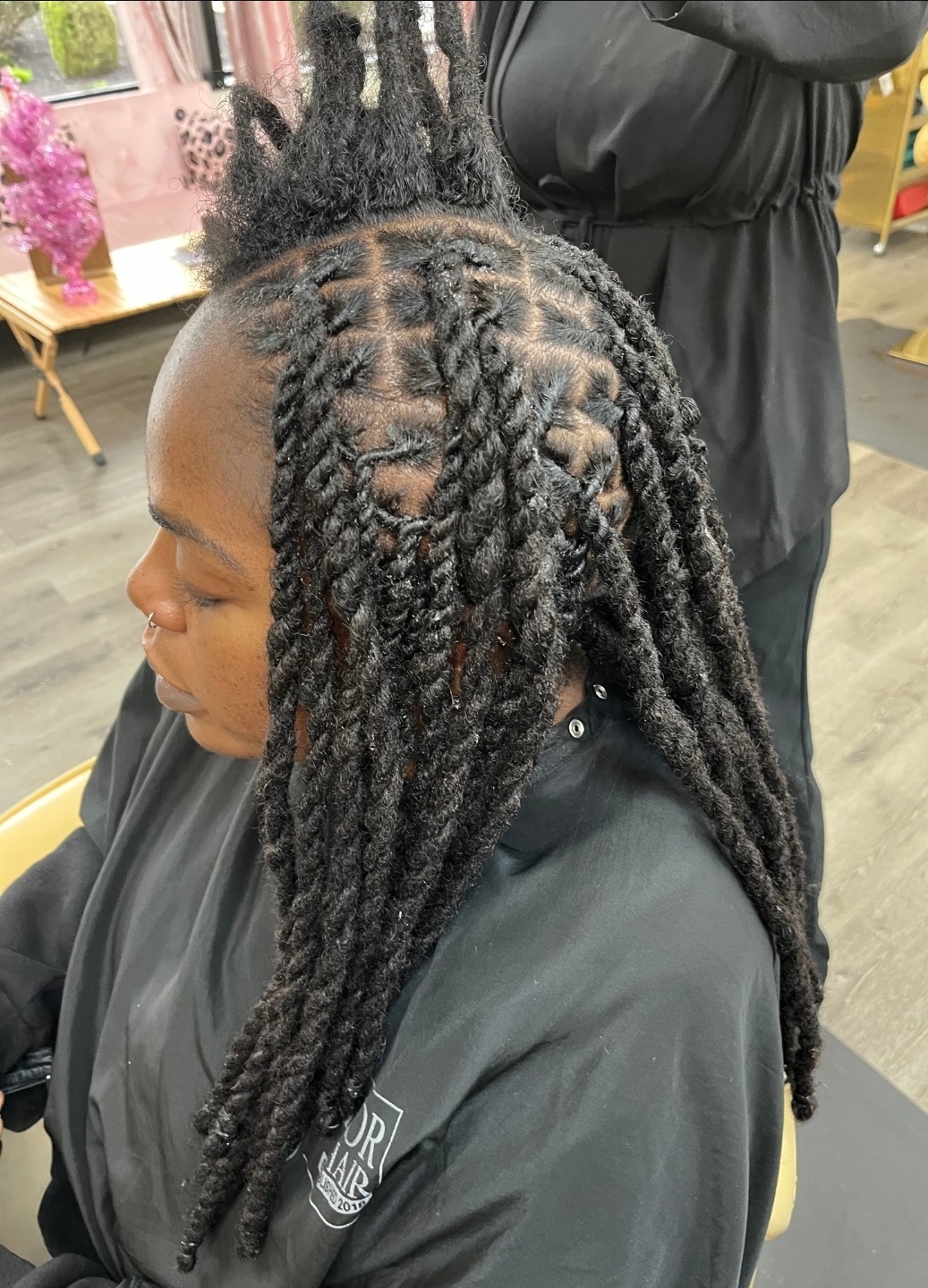 Starter locs near me — loctician installing dreadlocks at Sinkor Beauty Salon Middletown DE loc maintenance Delaware