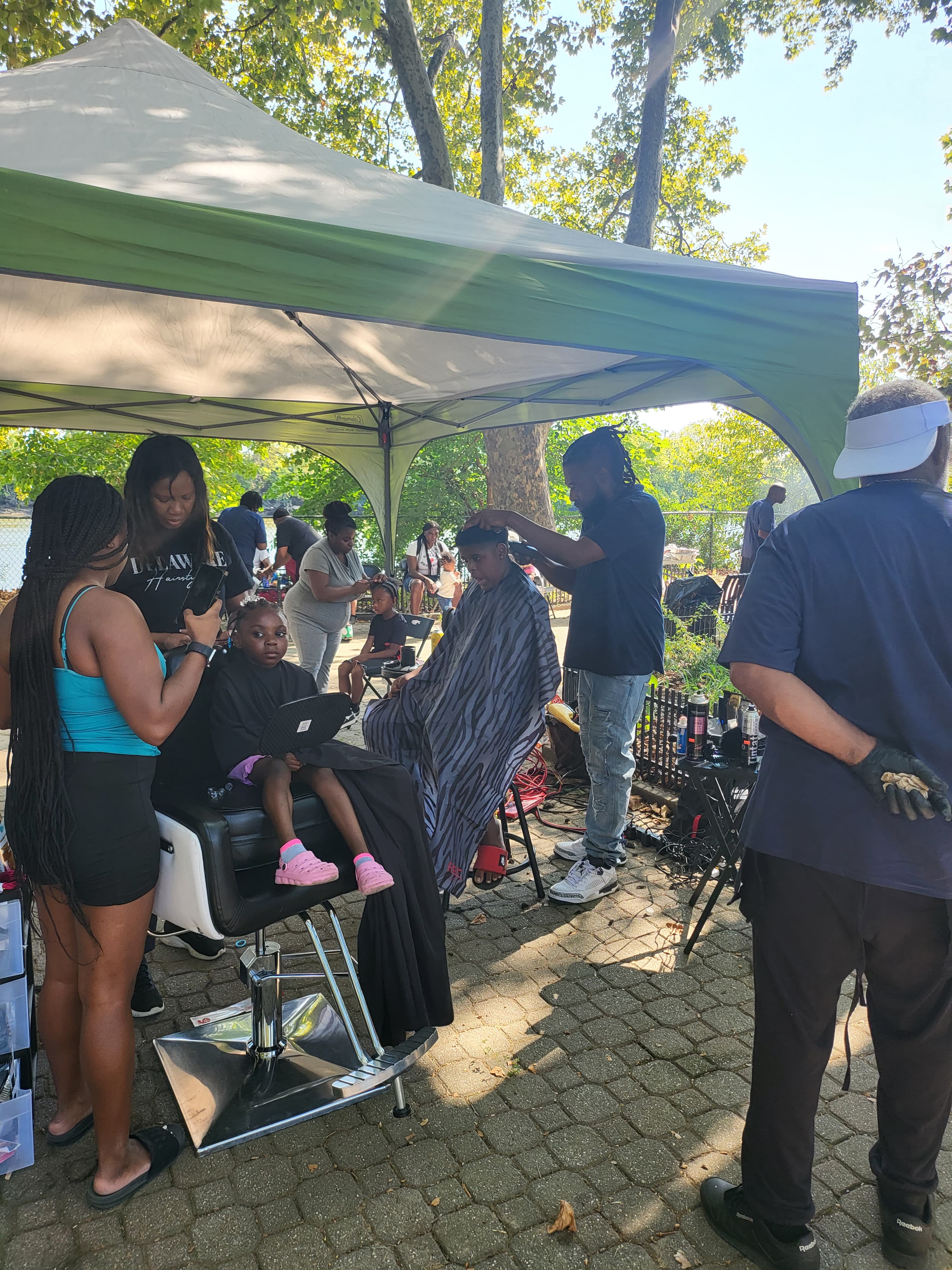 Sinkor full team working at outdoor community event under tents